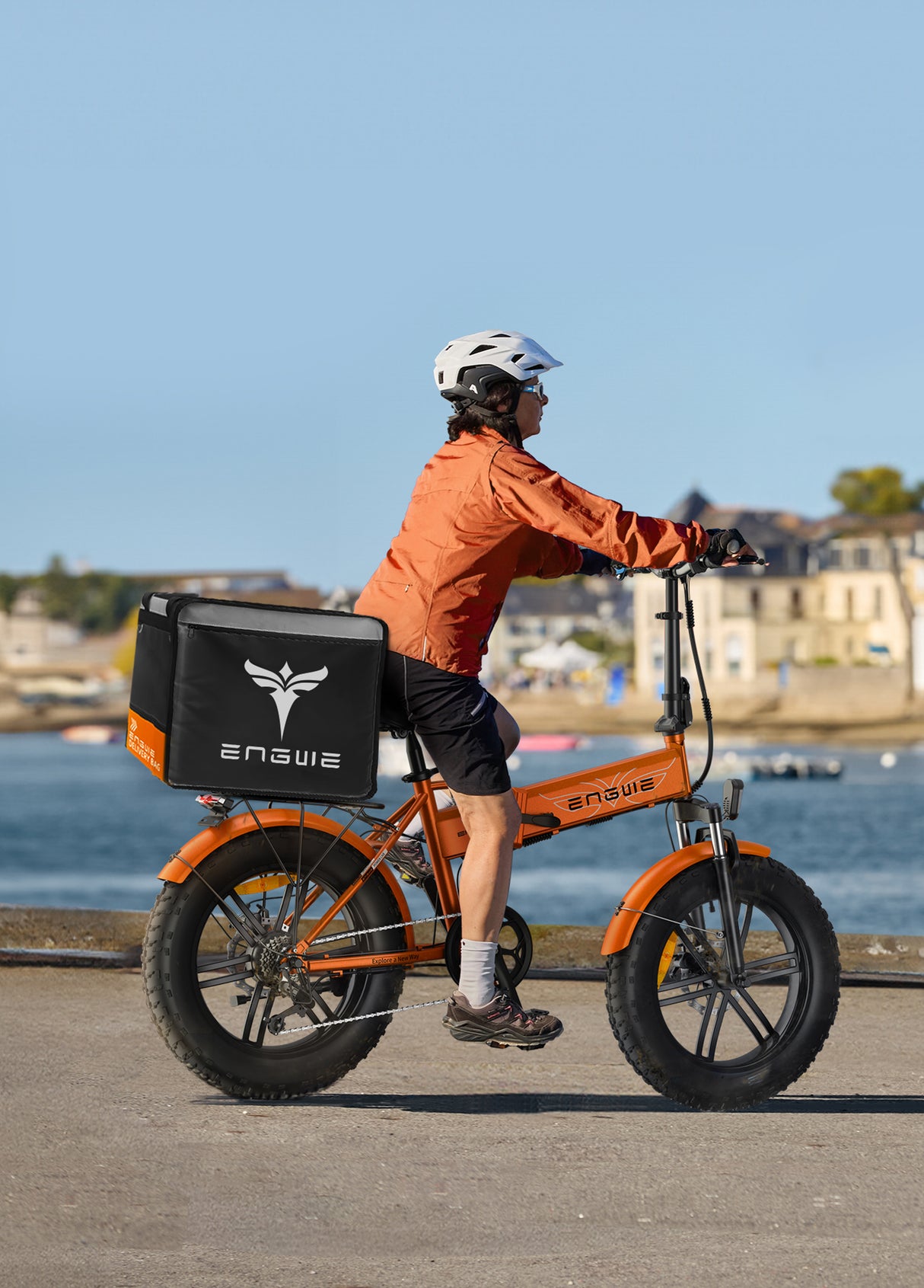 a person riding an engwe ep-2 boost fold up e bike with a takeaway box