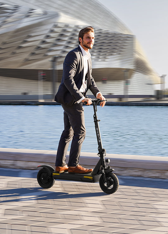 a man commutes using an engwe s6 electric scooter