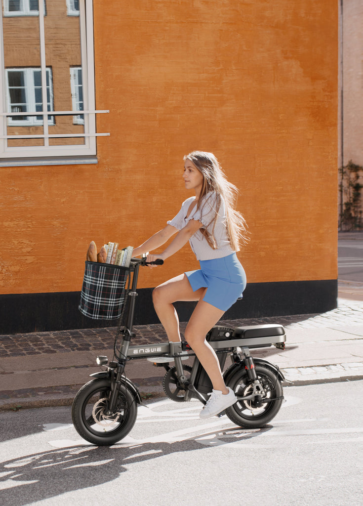 a girl ride a grey engwe t14 e-bike