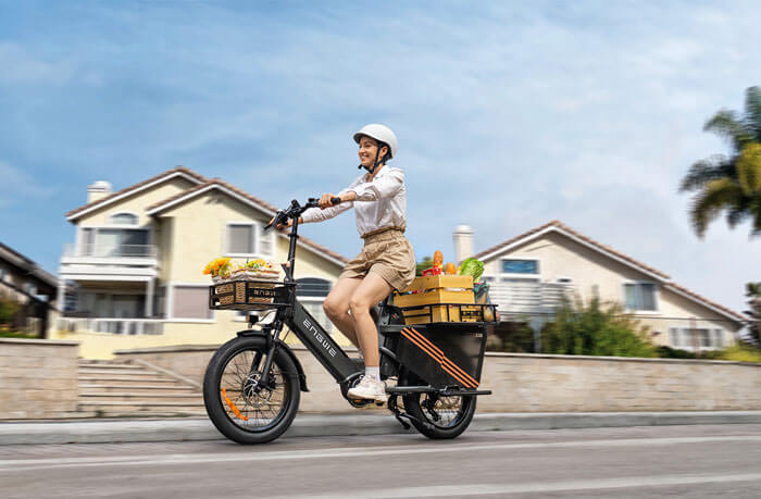 a woman riding a black engwe le20 long range electric bike on the road