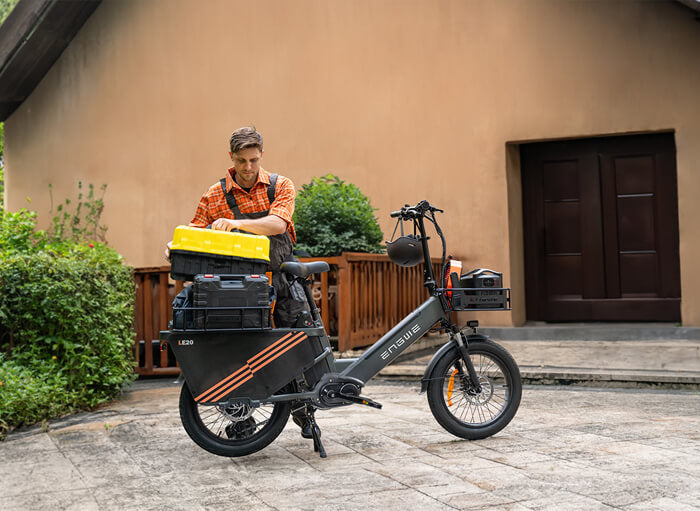 a man taking a box off a parked engwe le20 electric bike for delivery