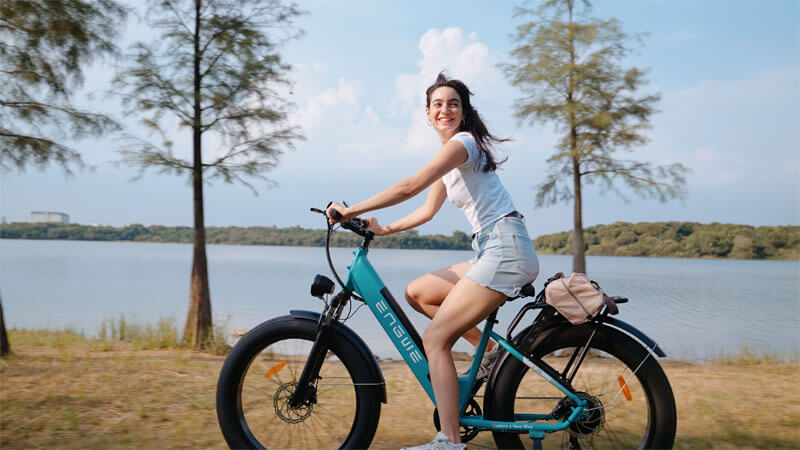 a girl riding an electric hybrid bike - engwe e26