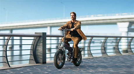 a man riding a black e-bike on the road