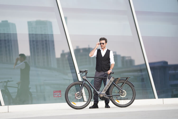 a man stands next to a men's electric bike - engwe p275 pro