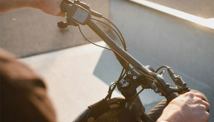 a man holding a black bicycle handle bar