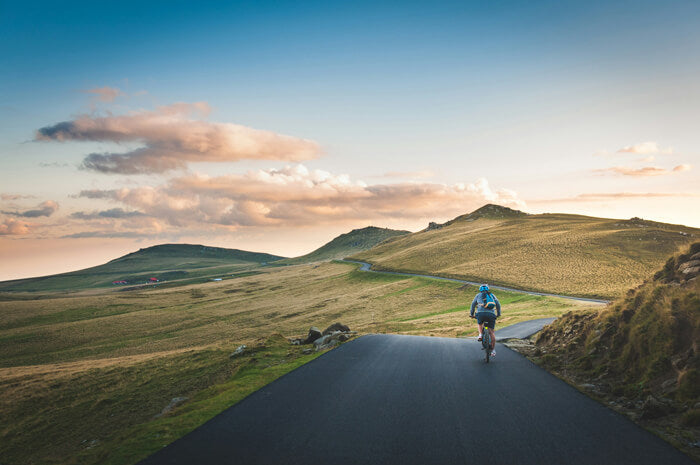 a man rides a bicycle on the road