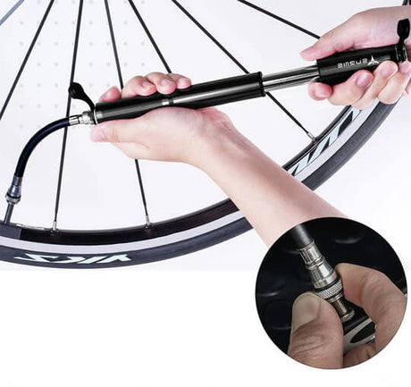 a person is pumping a bike tire