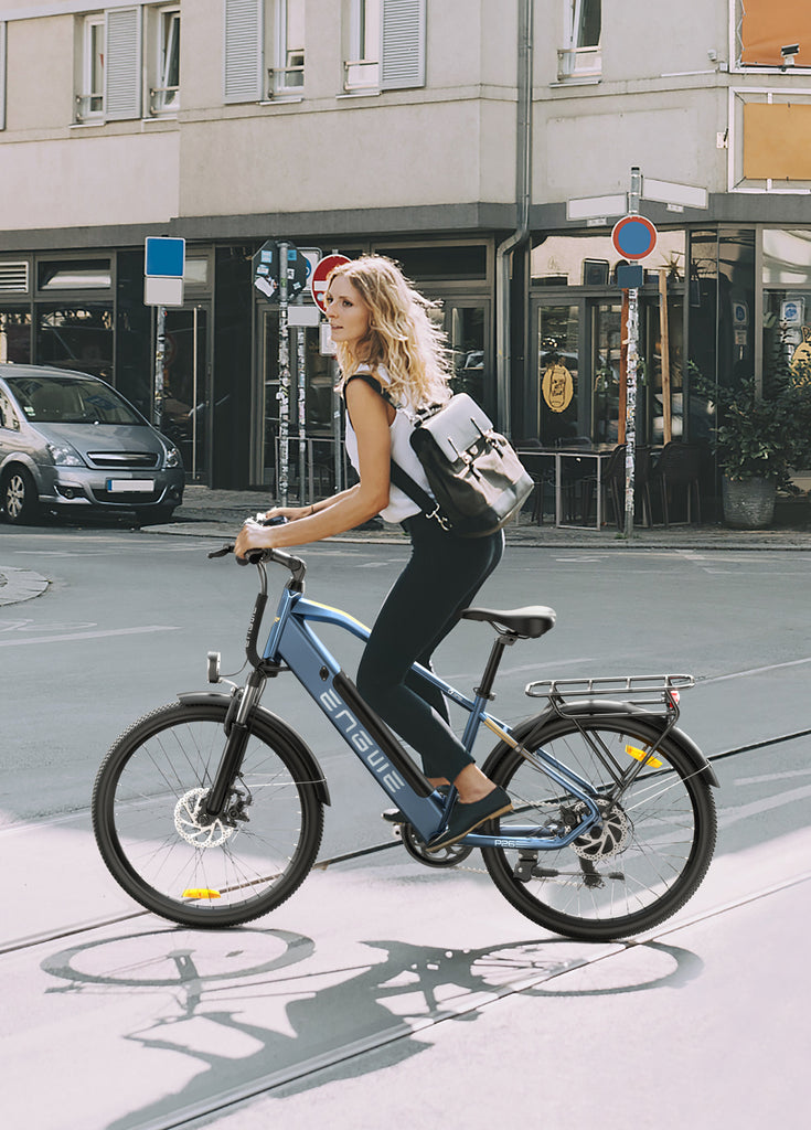 a girl rides a blue engwe p26 electric commuter bike